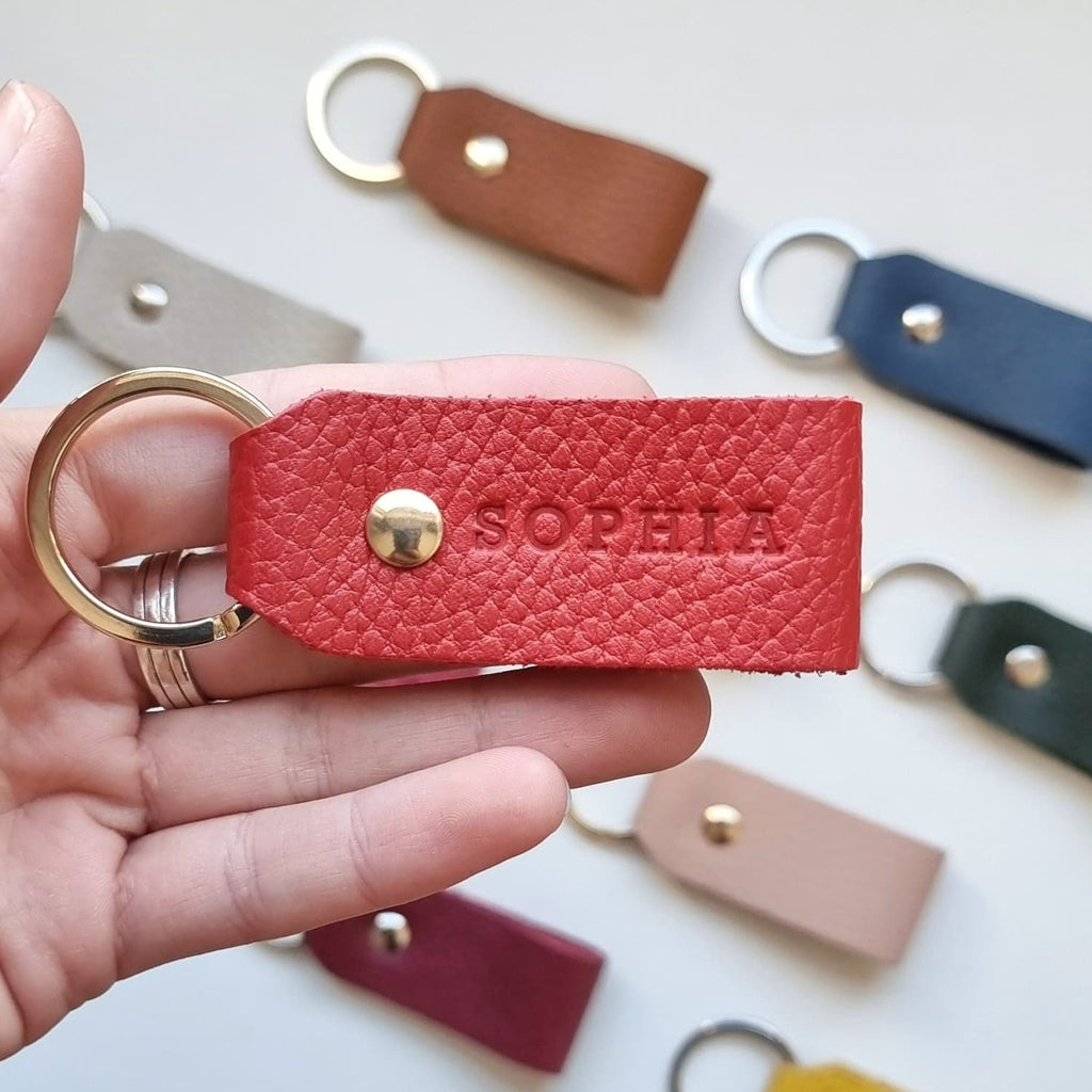 Close-up of brown leather keyring with initials, designed for her