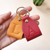 Personalized leather keychain with silver hardware and initial in foil